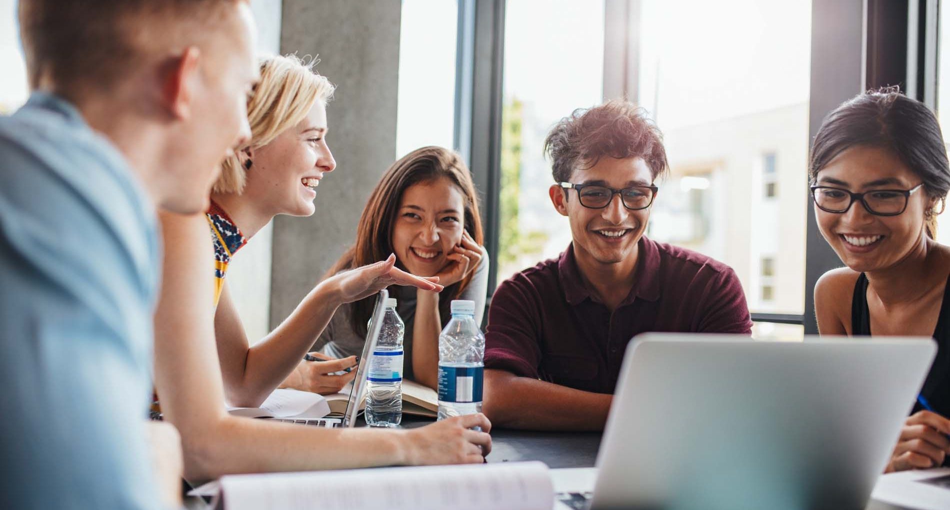University students sitting together at table