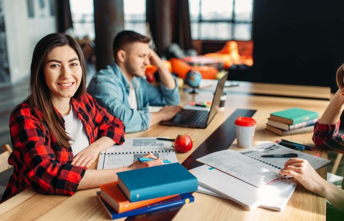 Group of university students sitting at the table